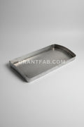 Metal tray on a reflective metal surface