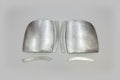 A pair of silver metal front corner fillers for an Isuzu Amigo vehicle.