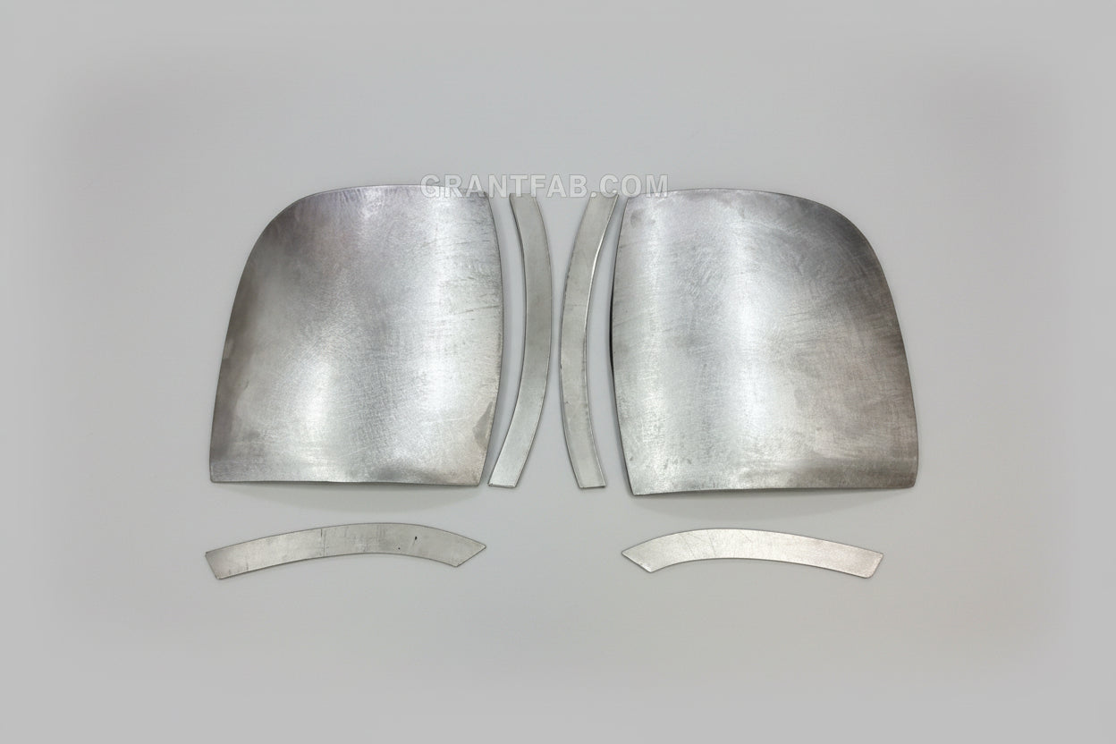 A pair of silver metal front corner fillers for an Isuzu Amigo vehicle.