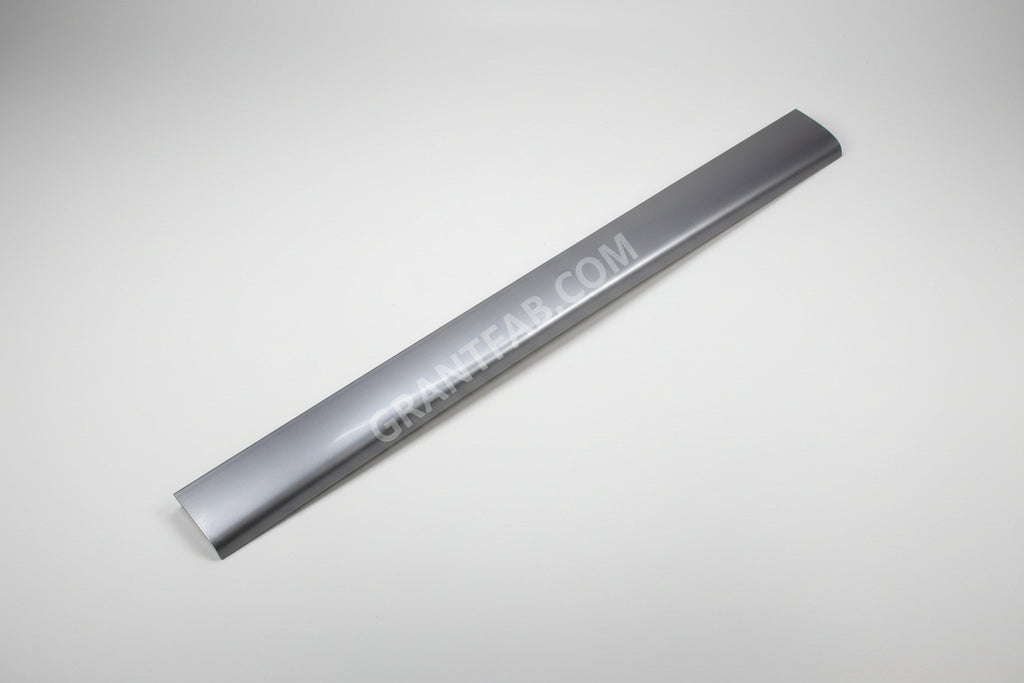 A silver-colored metal roll pan for a Ford vehicle, displaying a smooth, solid surface with a slight curve at one end.