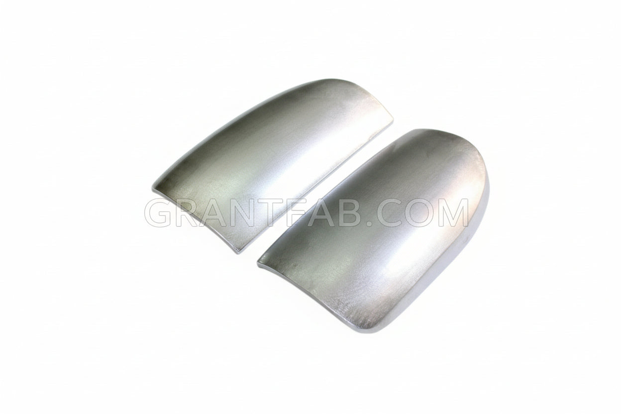 A pair of silver metal taillight fillers for a Toyota Tacoma vehicle.