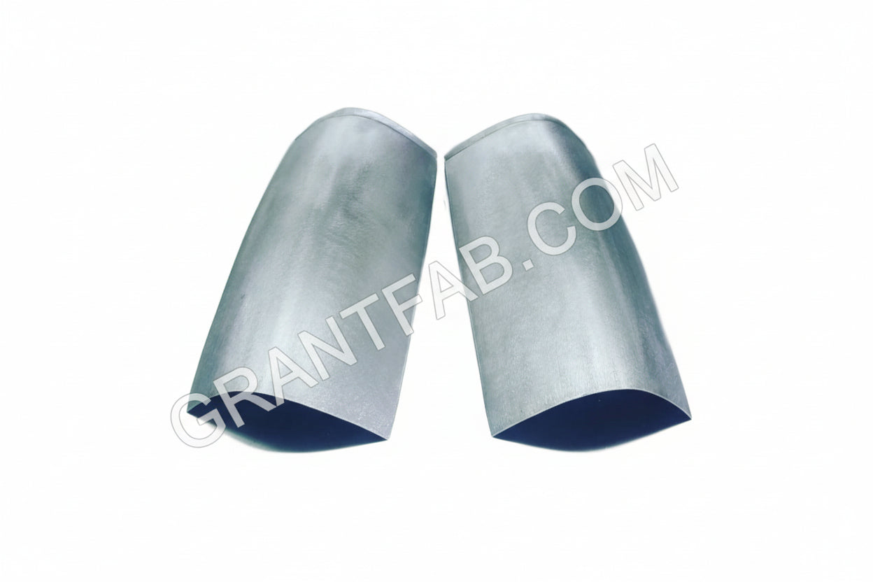 A pair of handmade steel taillight fillers for a Chevy vehicle.
