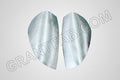A pair of silver sheetmetal taillight fillers for a Chevy Colorado vehicle.