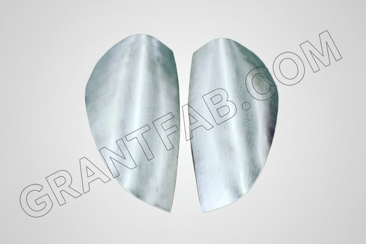 A pair of silver sheetmetal taillight fillers for a Chevy Colorado vehicle.