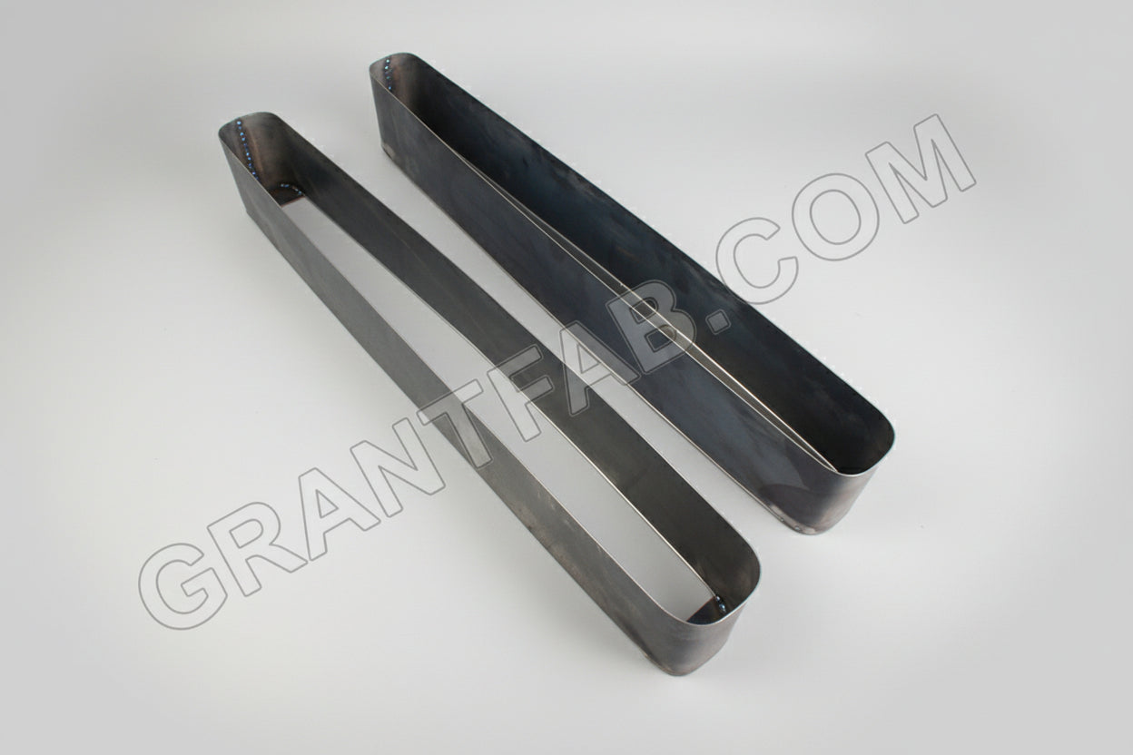 A pair of green metal car buckets for 89-93 Cadillac vehicles, made from 20 gauge sheet metal.