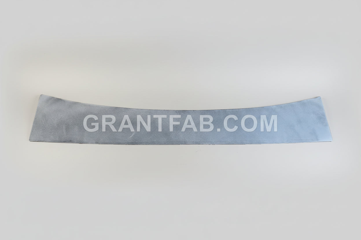 A gray metal wiper cowl filler piece for a Mazda B-Series vehicle.
