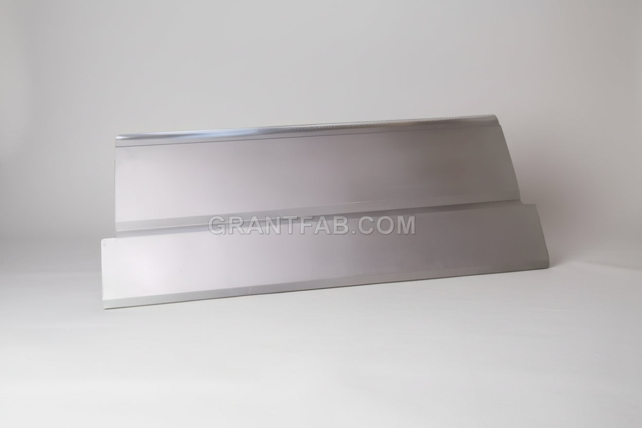 A silver-colored metal automotive part with a smooth finish, likely a bumper or paneling component.