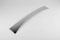 A silver-colored metal wiper cowl filler piece for a Nissan vehicle.