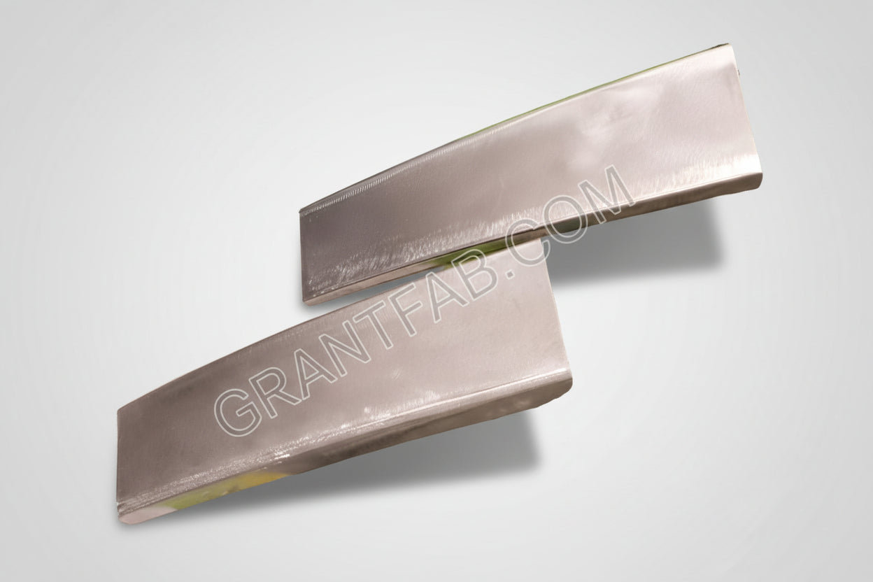 A pair of silver-colored metal pillar fillers for a Mazda vehicle.