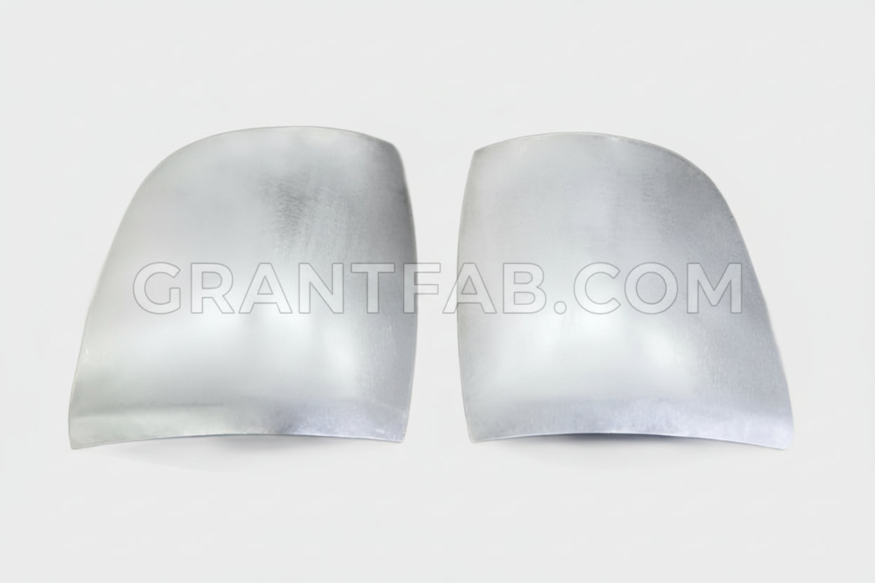 A pair of silver front corner fillers for an Isuzu vehicle.